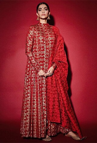 Scarlet red anarkali with gold tree trunk print. Paired with matching churidar pants and dupatta.