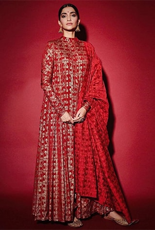 Scarlet red anarkali with gold tree trunk print. Paired with matching churidar pants and dupatta.
