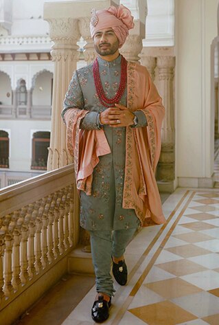 Grey sherwani set, with a detailing of embroidery. Paired with a baby pink stole.