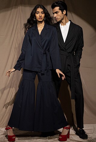 Side tie top paired with a matching fit and flair pant. Front Wrap blazer with a belt at the waist. Matching straight-fit pants.