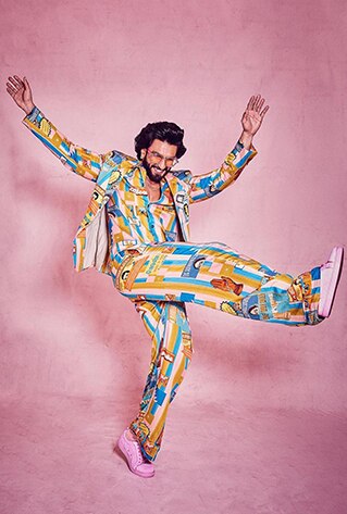 Unisex digital printed bowling shirt with metal buttons and wide-legged trousers. Paired with an oversized blazer.