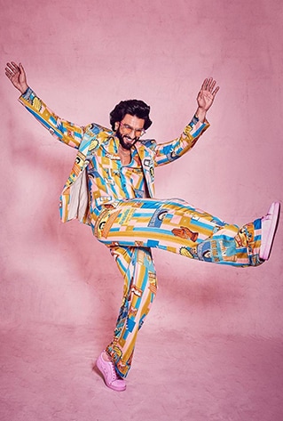 Unisex digital printed bowling shirt with metal buttons and wide-legged trousers. Paired with an oversized blazer.