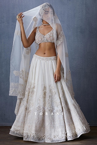 Ivory lehenga in organza silk with hand embroidered and embellished floral latkans.