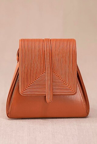 A tan structured shoulder bag in PU and faux leather base with cord embroidery.