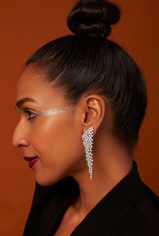 A pair of white finish dangler earrings studded with faux diamonds, set in mixed metal.