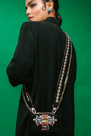 Black mini crossbody bag in suede base with embellishments and a detachable embroidered strap.