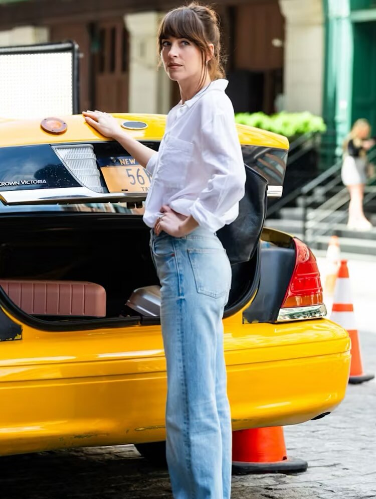 Dakota Johnson in plain white shirt and light blue Denim jeans