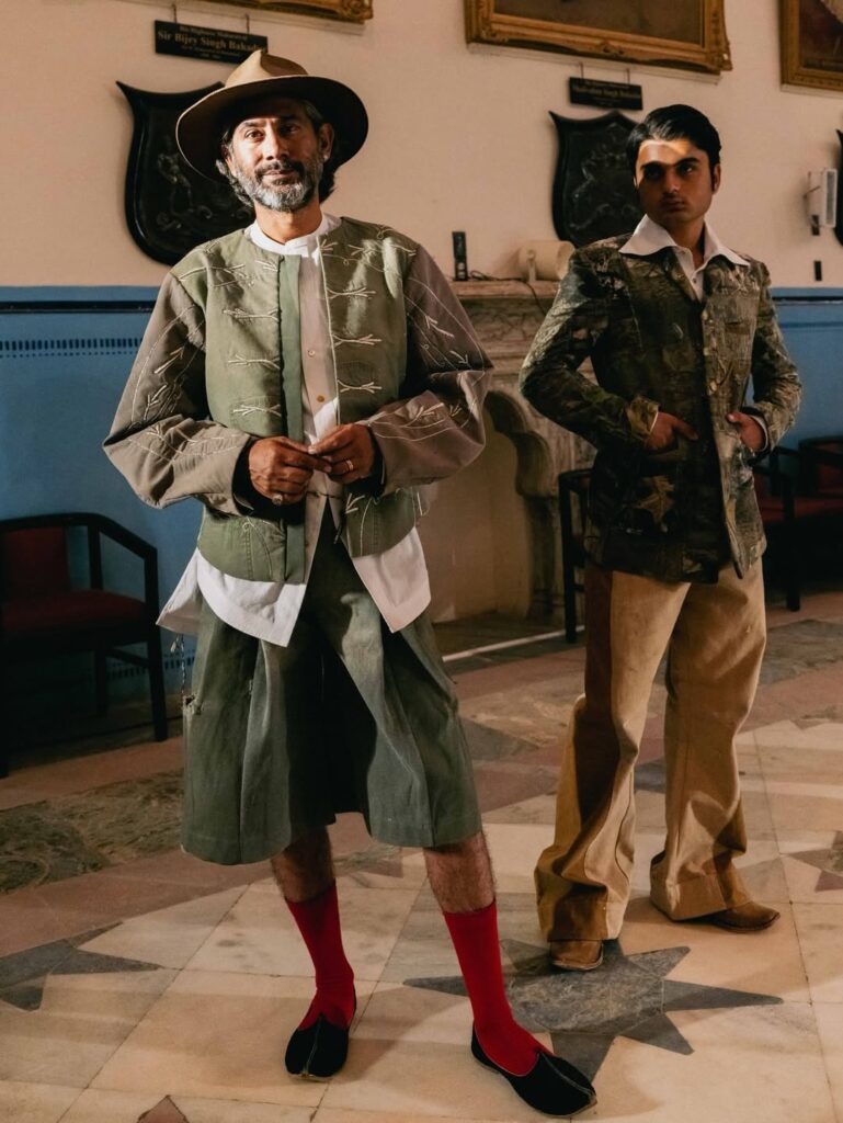 Runway shot highlighting the signature leheriya headpiece used throughout the collection