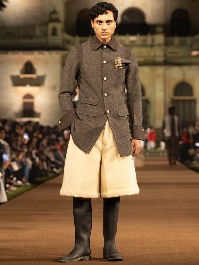 Model lineup showcasing reconstructed pieces such as embellished hoodies and reworked uniforms